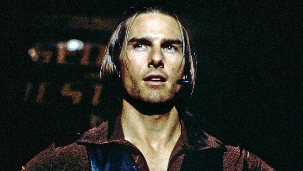 Tom Cruise, with long hair, look left off screen.