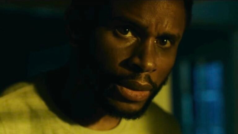 Close-up of Nnamdi Asomugha from The Knife movie. Intense stare, dark lighting, dramatic film scene.