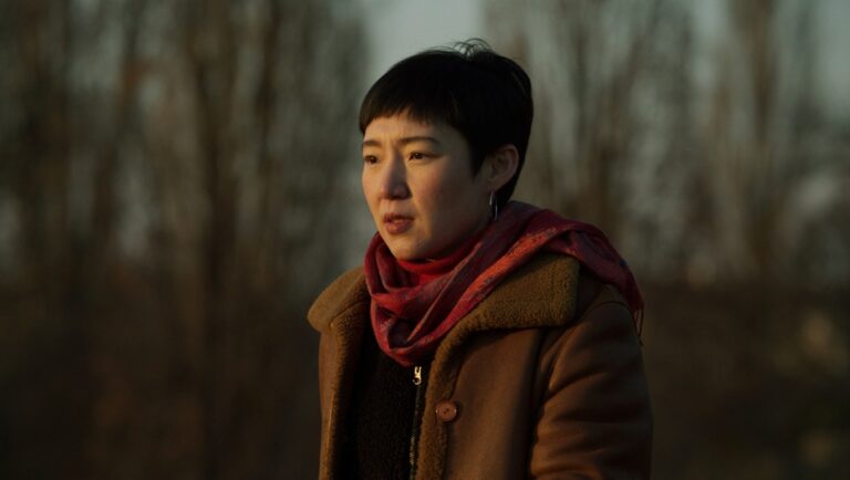 Woman in coat and scarf. Portrait of actress from The Plant from the Canaries film. DFFB production.