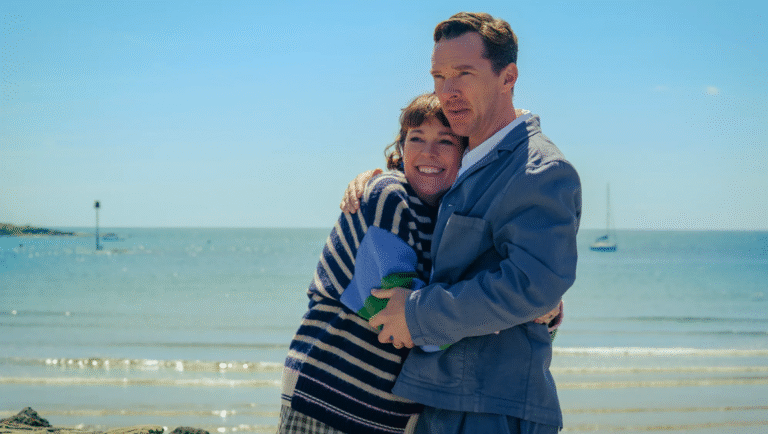 Benedict Cumberbatch and Olivia Colman hugging on a beach. The Roses movie scene. Searchlight Pictures film.