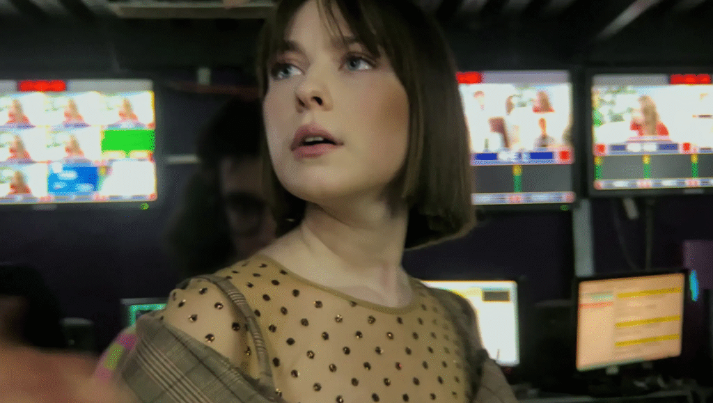 Mae Whitman in Up Here at a TV studio. Monitors display scenes. Undesirable Friends review.