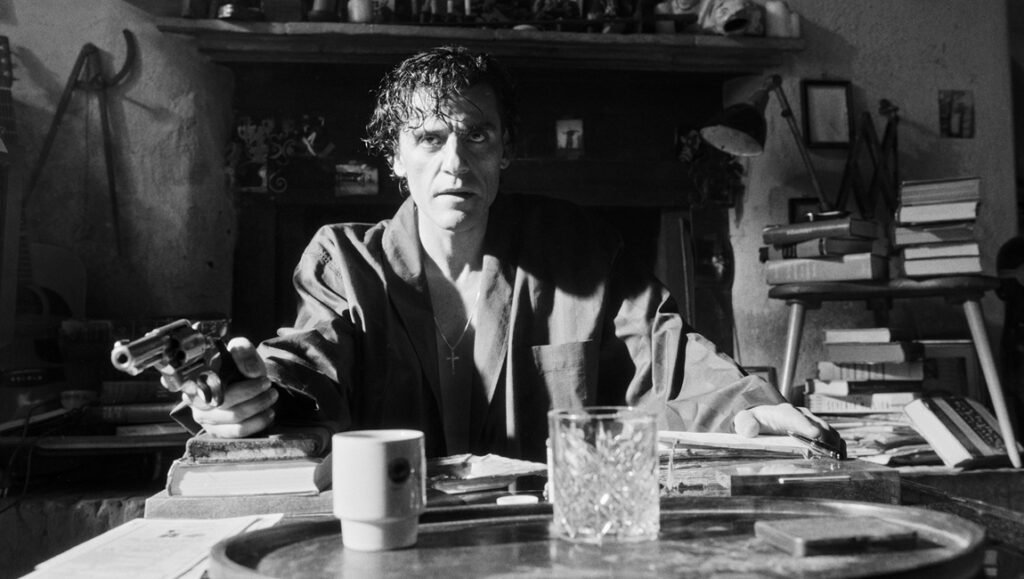 Oscar Isaac in In the Hand of Dante movie. Black and white portrait of actor holding a gun. Alex Majoli photography.