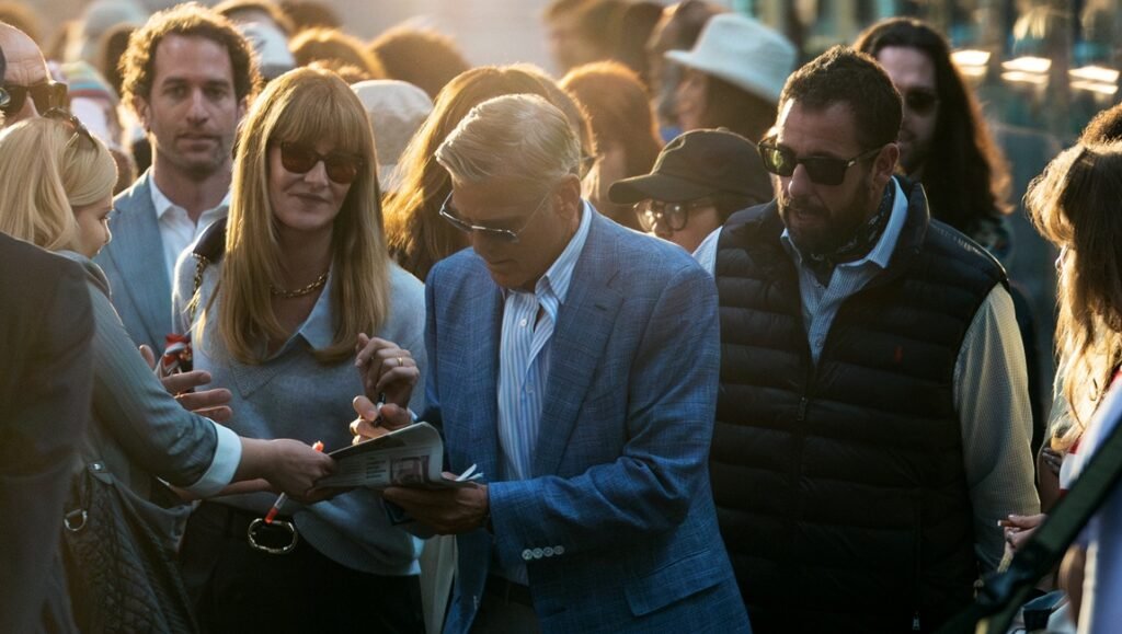 George Clooney signs autographs at the Venice Film Festival. Celebrities and fans. Venice, Italy.
