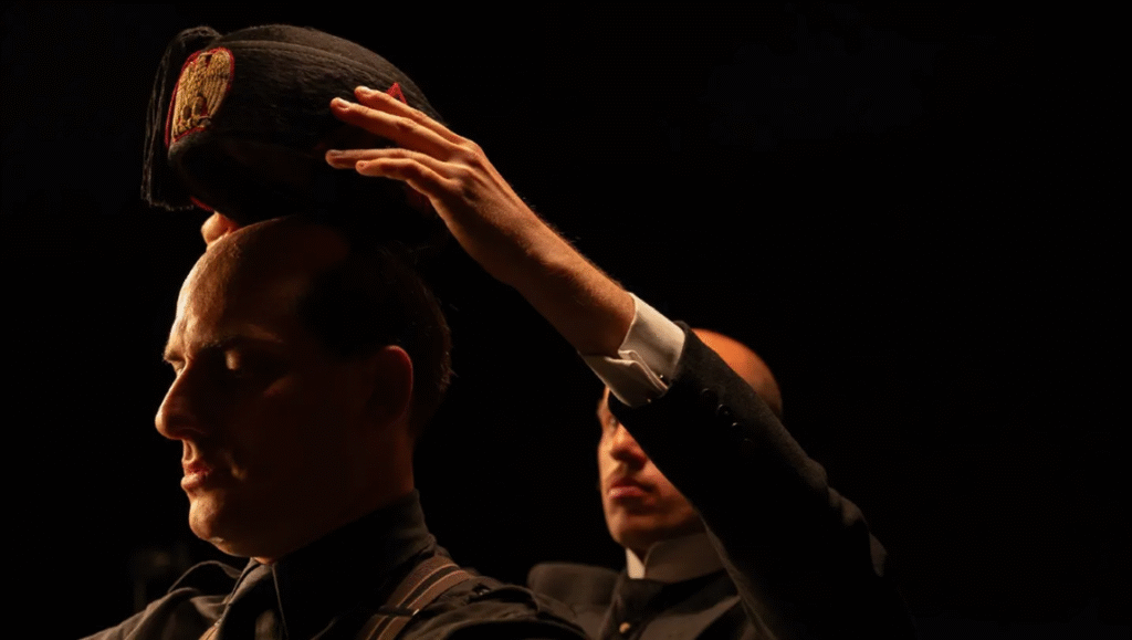 The Man Who Pretended to be Mussolini and M: Son of the Century Luca Marinelli in M. Son of the Century. Actor puts military hat on another man. Andrea Pirrello photo.