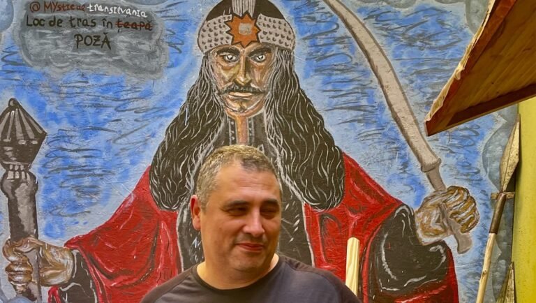 A Huge Shawarma With Everything: Radu Jude on Dracula Director Radu Jude stands in front of a Dracula painting. Raluca Munteanu photo.