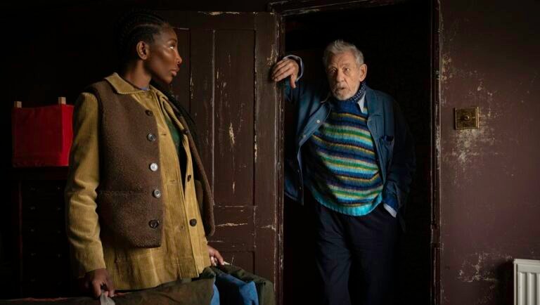 The Christophers film still. Man at doorway, woman with bag. TIFF 2025.