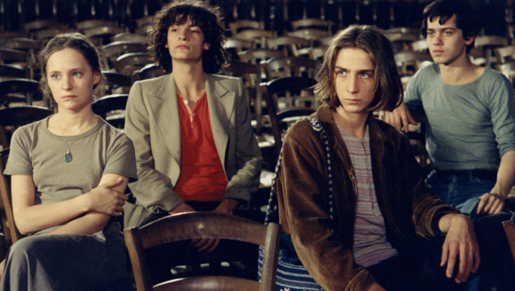 The Devil, Probably film still. Young cast sitting in rows of chairs. Robert Bresson film.