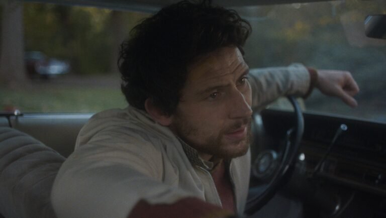 NYFF 2025 — Dispatch 2: The Mastermind, Escape, Late Fame NYFF 2025 film still: Man driving a car. The Mastermind movie scene.