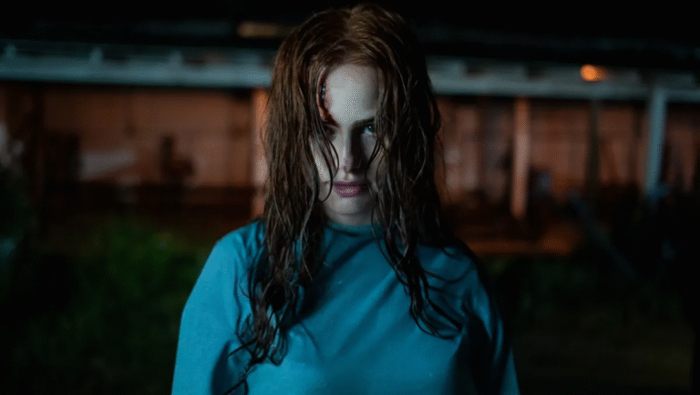 The Strangers Chapter 2 movie still. Woman with a head wound stares intensely. Horror film.