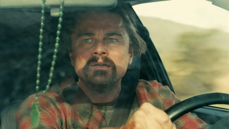 Leonardo DiCaprio in One Battle After Another movie review. Actor driving a car.