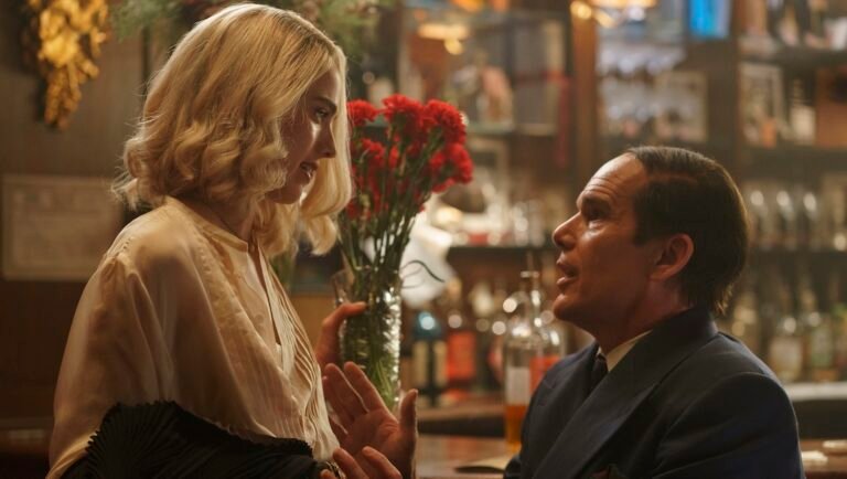 Blue Moon film still from NYFF 2025. Woman and man in conversation at a bar.