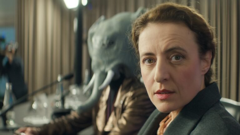 Gavagai NYFF '25 film review: Woman and person in elephant mask. Ulrich Köhler film still.
