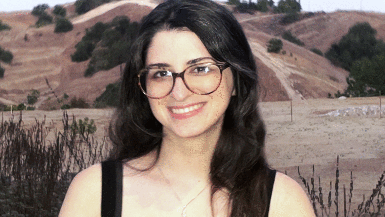 A Never-Ending Pile-On: Sabrina Greco on Lockjaw Sabrina Greco, Lockjaw's author, headshot. Woman with glasses smiling in front of a hill.