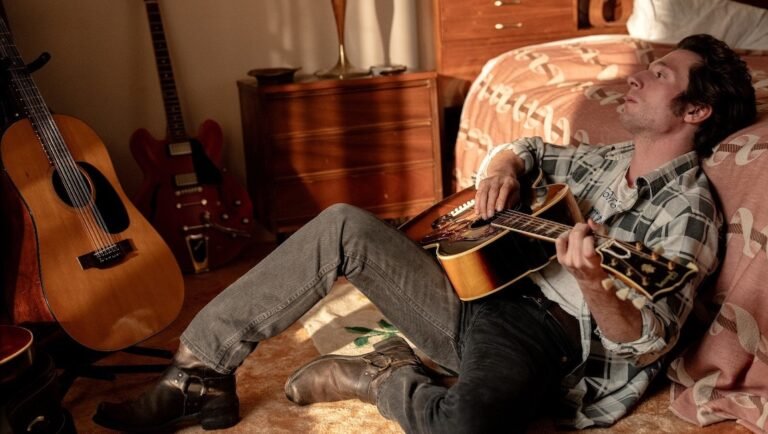 Andrew Garfield as Bruce Springsteen with guitar in Deliver Me From Nowhere.