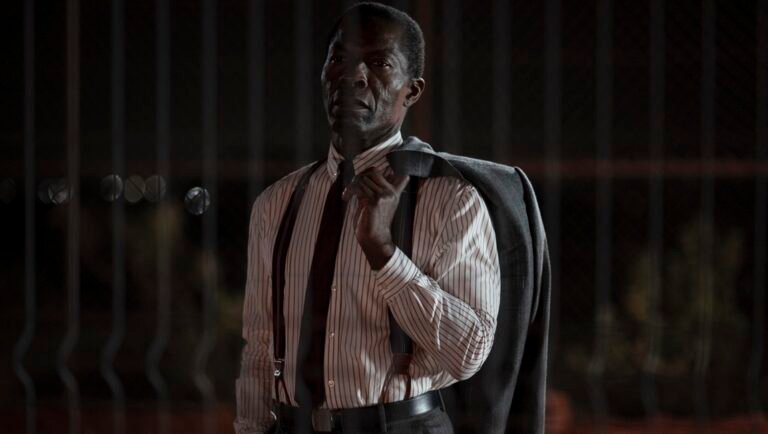 London Film Festival: Scene from The Fence film. Man in shirt, tie, and suspenders with a jacket over his shoulder.