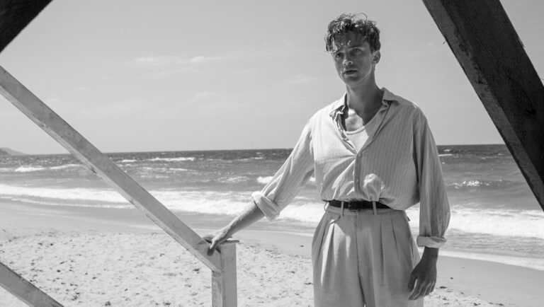 Still from The Stranger at London Film Festival. Man on beach in black and white.