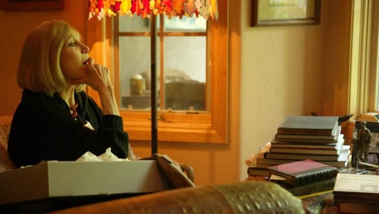 Kim Novak in Vertigo documentary. Alexandre O. Philippe film review. Woman thoughtfully seated.