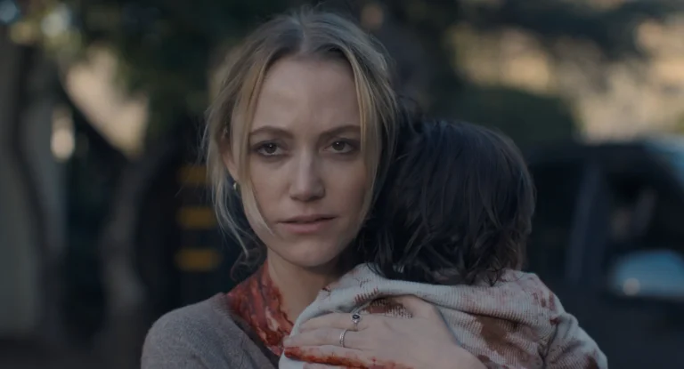 The Hand That Rocks the Cradle movie review: Woman holds child, both covered in blood. Horror film still.