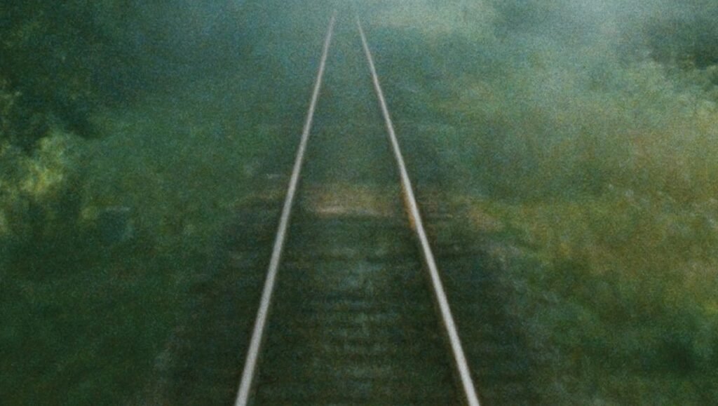 Railroad tracks stretch into the distance, evoking the Shoah. Criterion Collection.