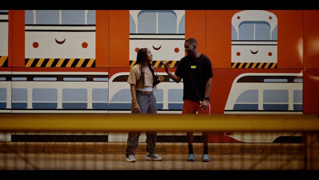 Reza Dahya conversation. Two people in front of a train mural. Vulnerability concept.