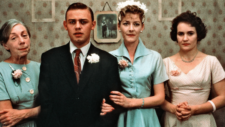 A World Gone Away Forever: Terence Davies’ Distant Voices, Still Lives Distant Voices, Still Lives film still. Cast portrait: family in formal attire, vintage style. Terence Davies movie.