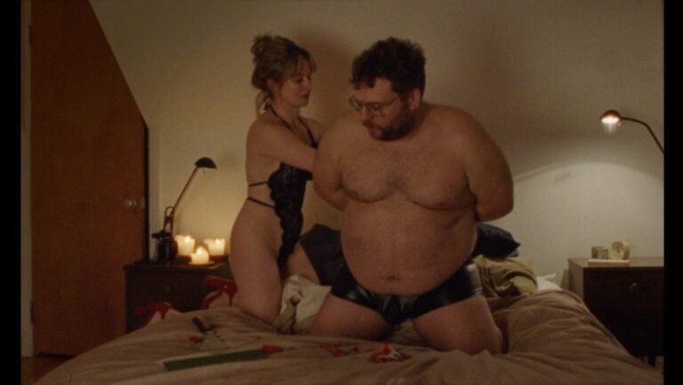 Tallinn Black Nights Film Festival scene: Woman in lingerie tying man's hands in 'Follies', a tale of wounded land.