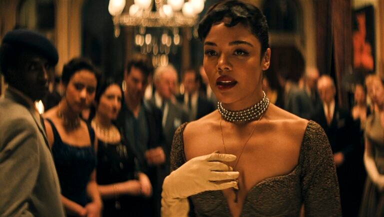 Tessa Thompson at party. Elegant dress, gloves, and jewelry.