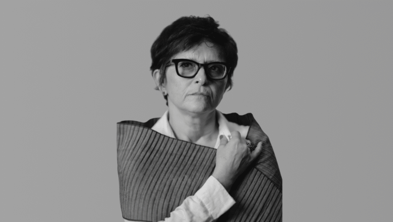 Black and white portrait of Sepideh Farsi wearing glasses. Iranian film director.