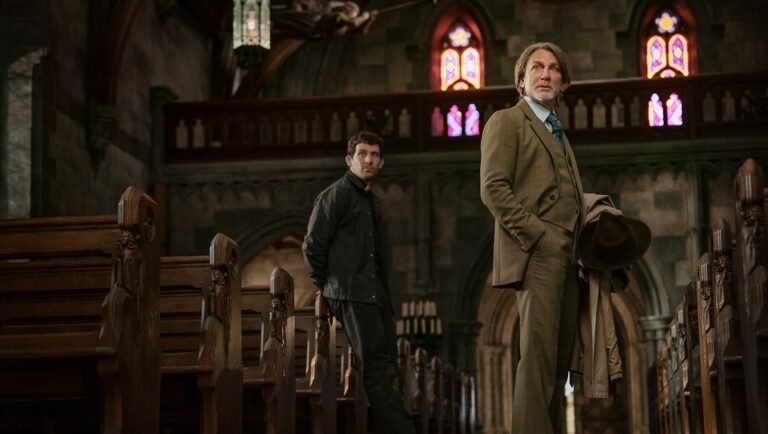 Two men in church. One in suit holding hat, the other in jacket. Stained glass windows. Drama scene, WUDM_20240619_03917_R.jpg