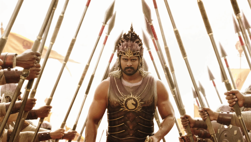 October 2025 — Reviews Roundup Baahubali review: Prabhas as warrior in epic film. Soldiers with spears surround the hero.