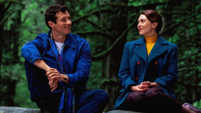 Eternity 2025 movie review: Man and woman looking at each other, wearing blue coats, romantic drama film.