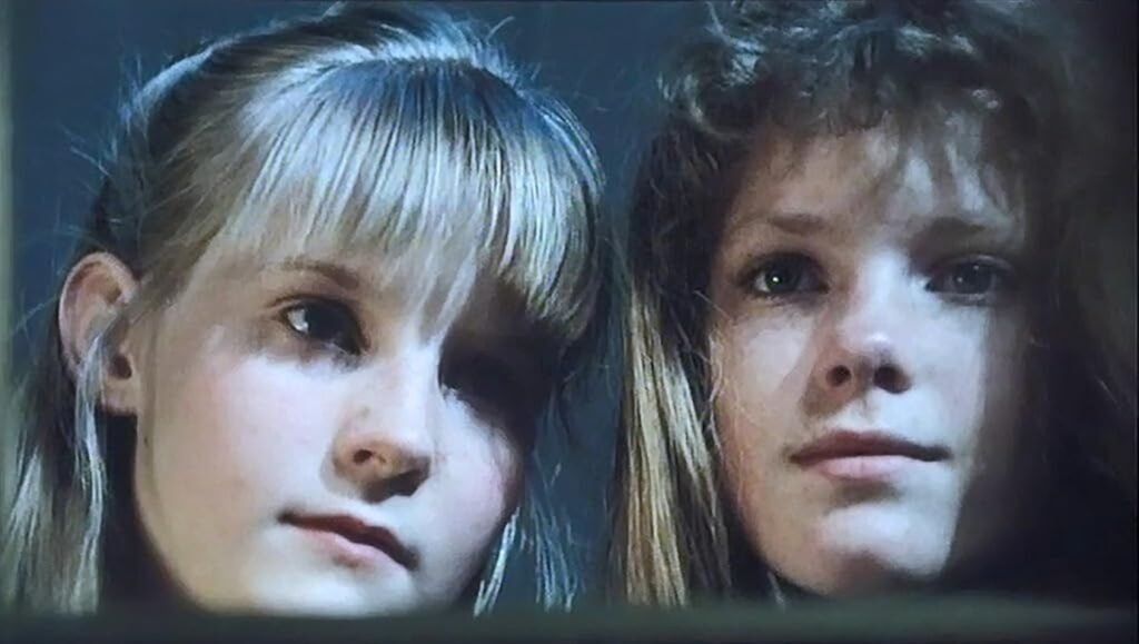 Ice Palace film still: Two young girls, blonde and brunette, stare intently at the viewer.