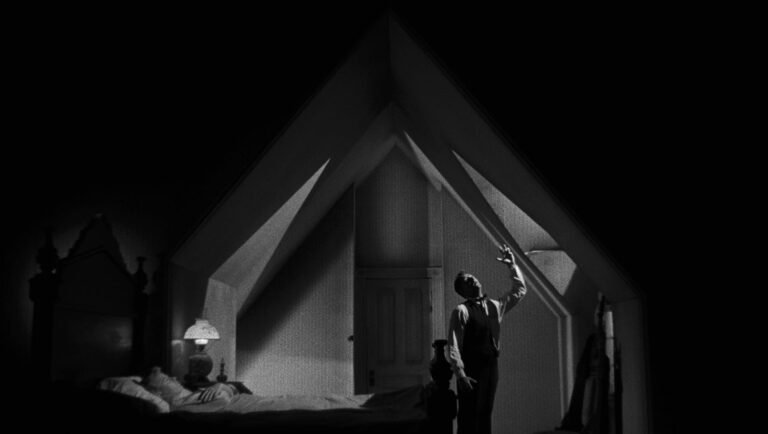 Darkness on the Edge of Town: Charles Laughton’s The Night of the Hunter Night of the Hunter: Criterion Collection. Black and white film still of a man in an attic bedroom reaching up.