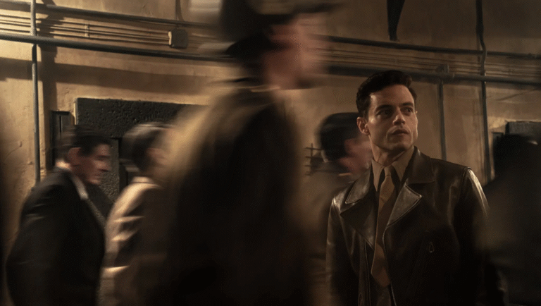 Rami Malek in Nuremberg movie review. Malek wears a leather jacket in the film about the Nuremberg trials.