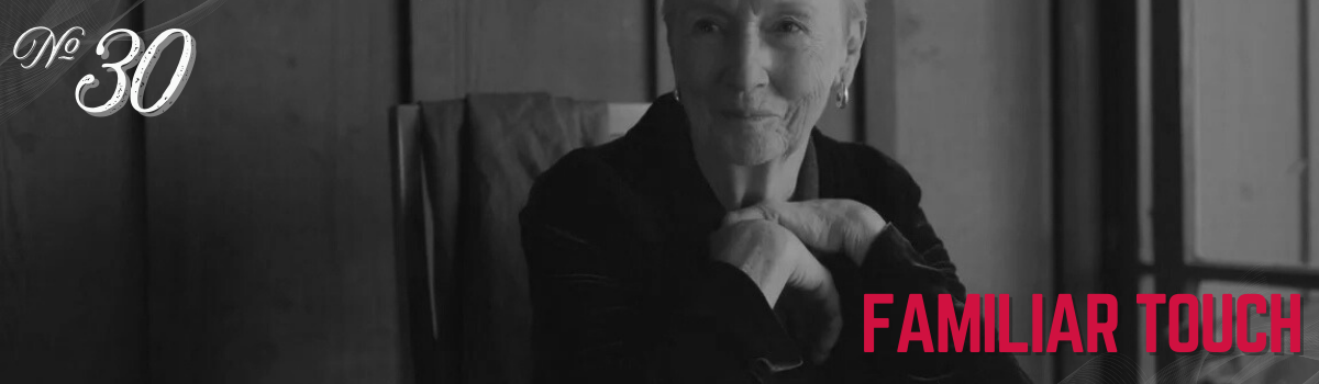 Black and white portrait of an older woman, 'Familiar Touch', number 30, evoking warmth and memories.