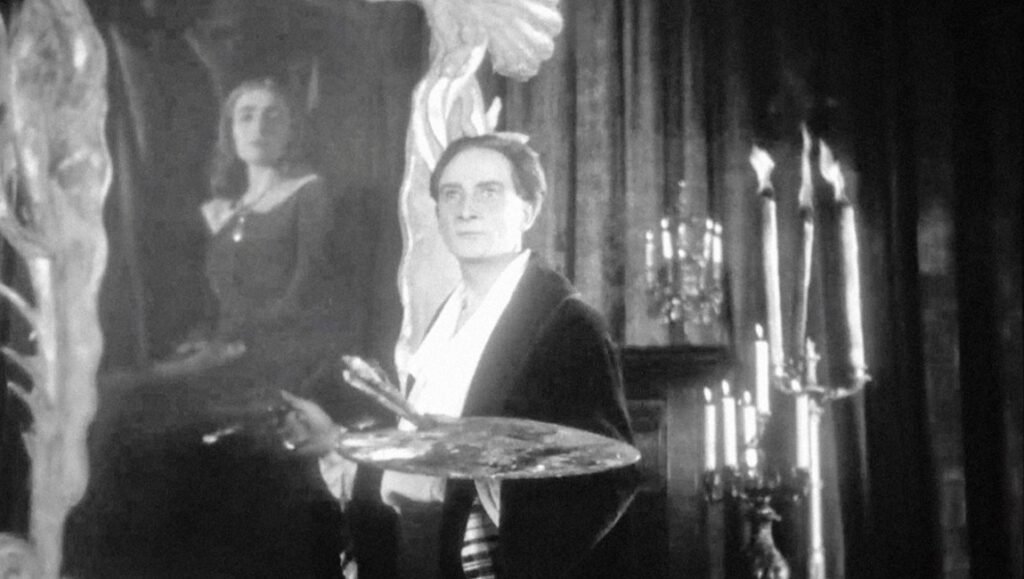 Jean Epstein's 'The Sea' film still: Artist with palette, painting a woman, Viennale 63, black and white.