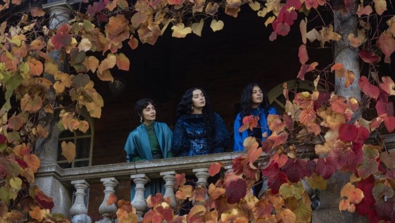100 Nights of Hero movie review: Three women stand on a balcony framed by autumn leaves, promoting the film's drama.
