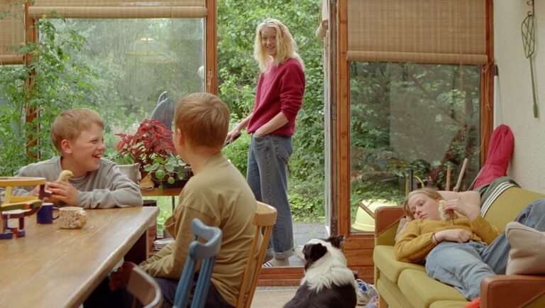 Still from "The Love That Remains" by Hlynur Pálmason: A family scene indoors with children, a woman, and a dog.