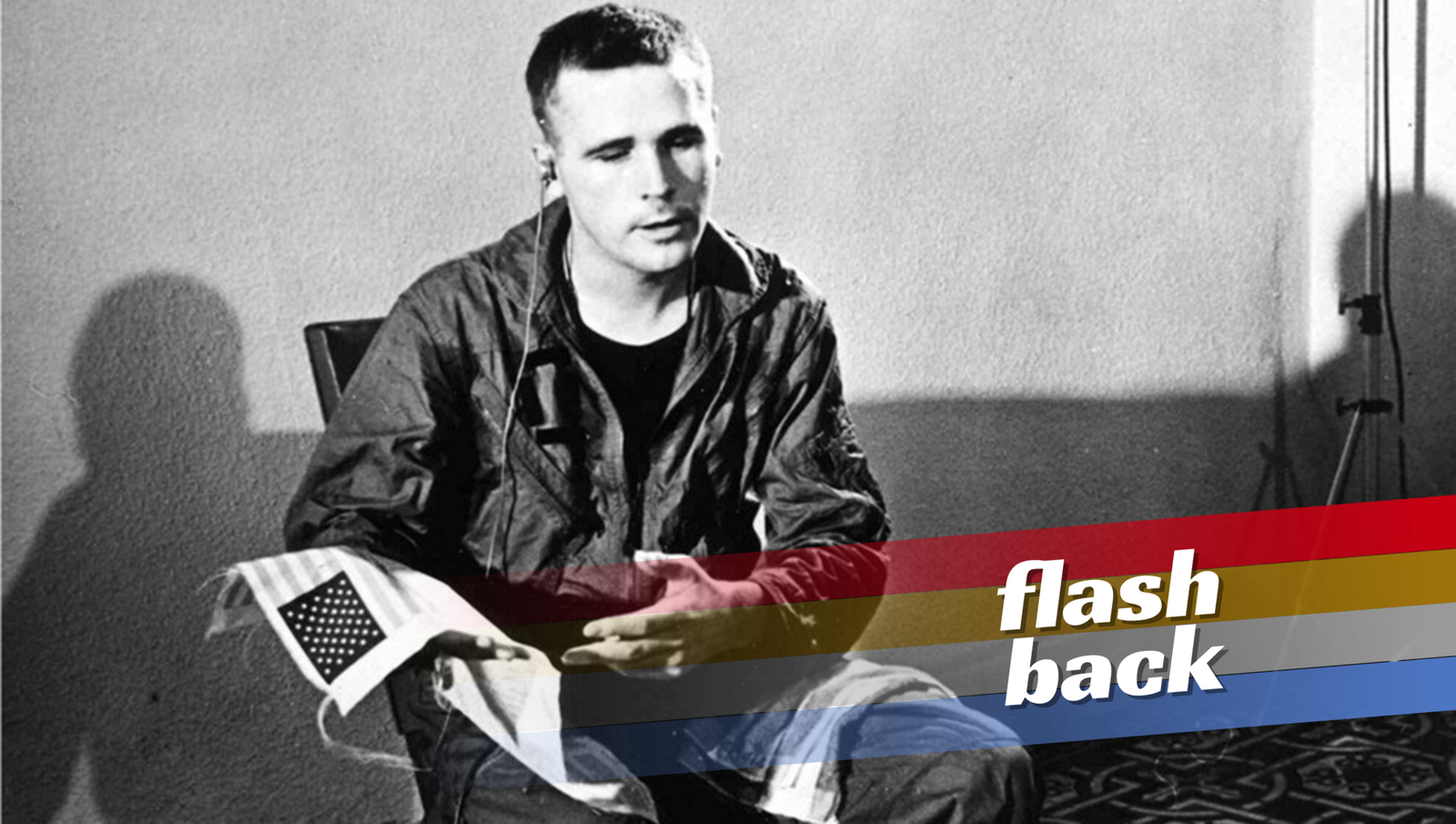 Just Doing Our Job: Heynowski & Scheumann’s Pilots in Pajamas Pilot in Pajamas flashback: A man, possibly a pilot, holds a small American flag in a black and white image.