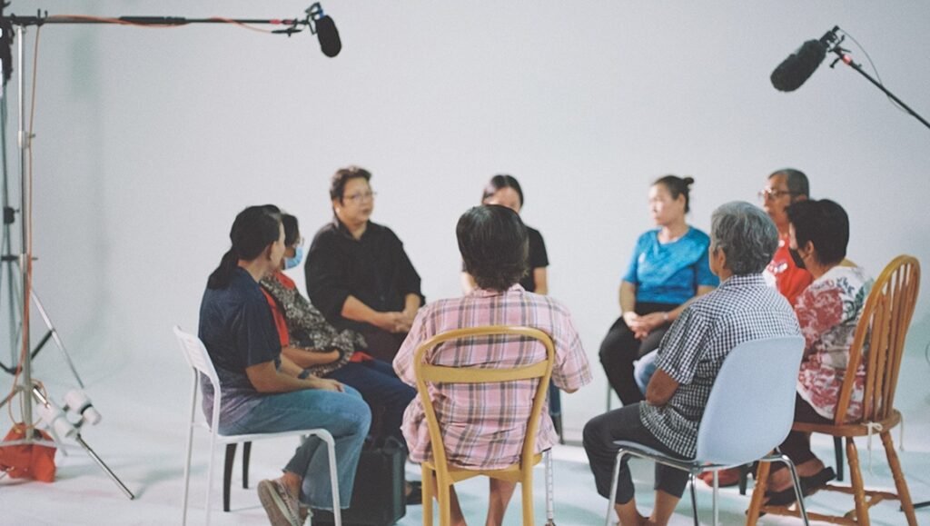 Doc Fortnight 2026 film scene: Group of people in a circle, likely discussing narratives of the Greater Bay Area.