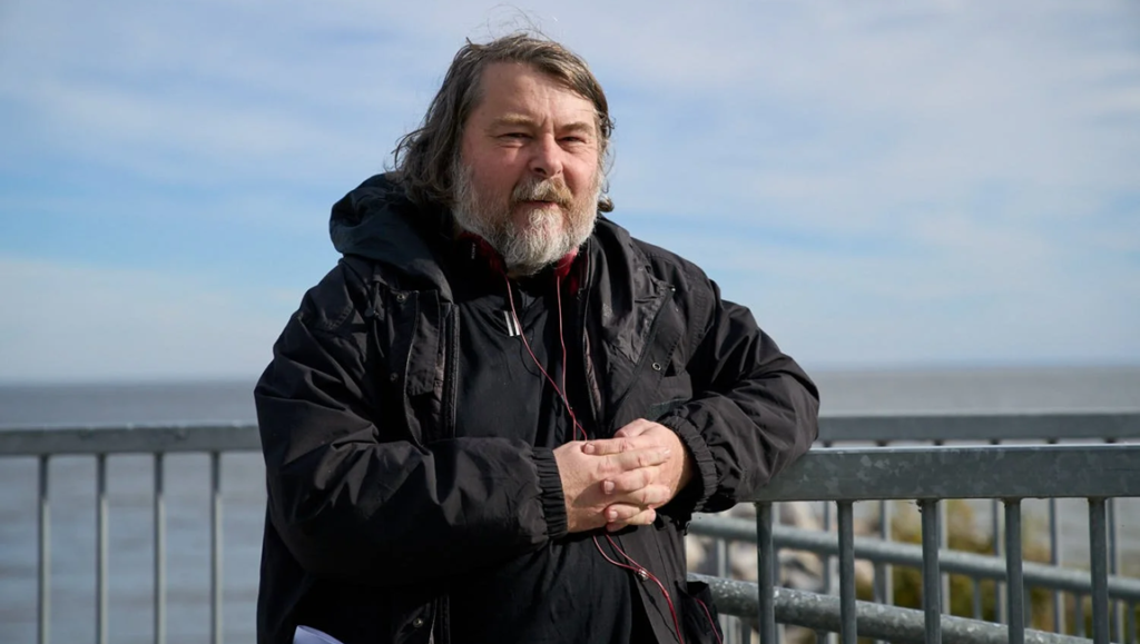 Ben Wheatley, film director, in a thoughtful pose. Portrait from "Taking Genre Seriously: A Normal Conversation with Ben Wheatley".
