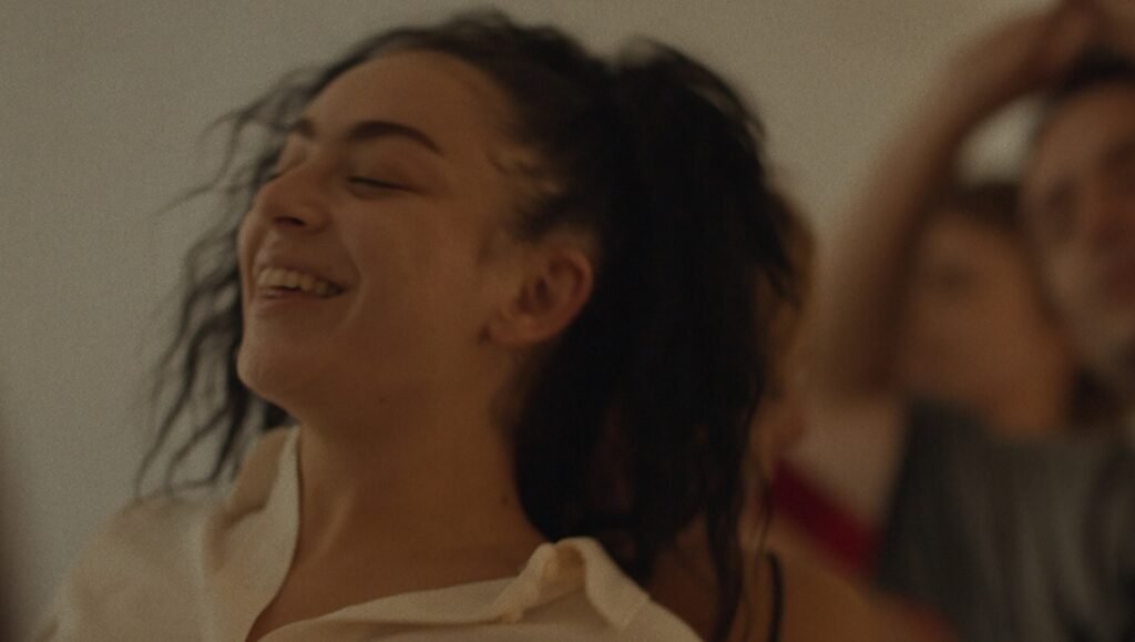 Pete Ohs interview still: A smiling woman with dark hair, captured in a candid moment, likely from 'Erupcja'.