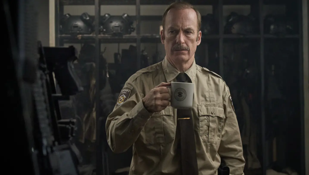 Bob Odenkirk in "Normal," a Ben Wheatley film. Sheriff holding a mug in a still from Allen Fraser. Genre conversation.