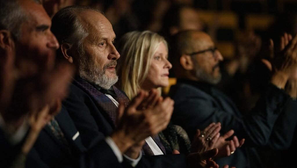 Audience applauding at "Two Pianos" by Arnaud Desplechin. Theater attendees showing appreciation for the performance.