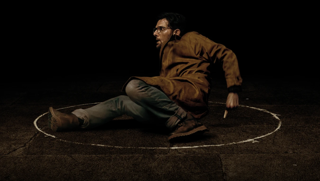 Hokum review image: Man drawing circle, distressed. Damian Mc Carthy film scene.