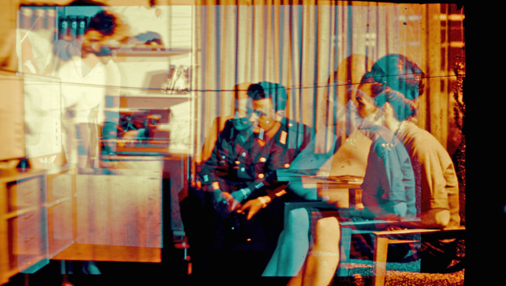 Abstract film still: A man in uniform sits, woman beside him, vintage, ddd First Look '26 review, Littlestabs, Brooklyn Z-grade director