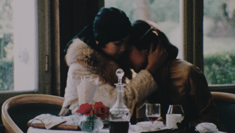 Small Feats of Human Intimacy: A Brief Survey of LAFM 2026 Intimate portrait of two women embracing at LAFM 2026, subtle shades of silk, capturing a small feat of human connection.