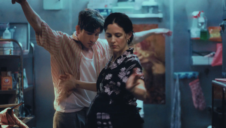 Couple dancing in kitchen. Man and woman embrace, moving romantically. Why Not Productions presents Butterfly Jam.