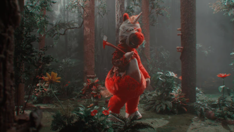 A bandaged red unicorn character holding an axe walks through a dark forest with a stereoscopic 3D color effect.