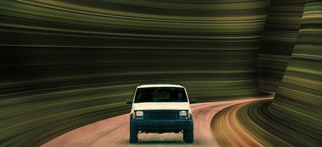 White SUV drives along a road bordered by surreal, streaking horizontal lines resembling a distorted tunnel.
